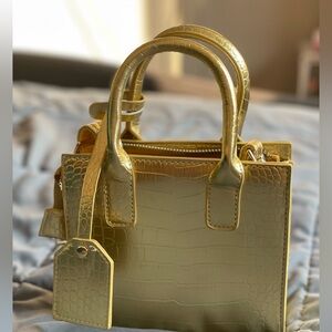 Gold mini Noir X purse.